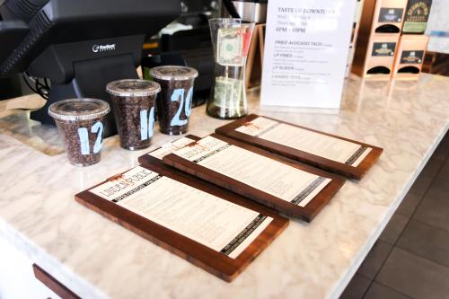 a counter with two cutting boards and cups on it at Broadlind Hotel in Long Beach