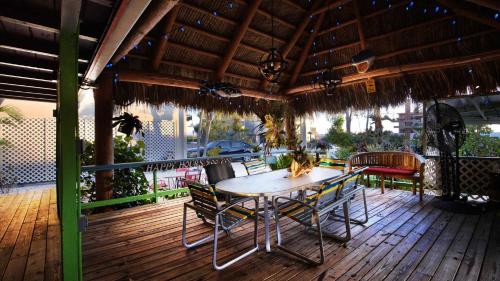 a patio with a table and chairs on a deck at BeachPoint Cottages in Siesta Key