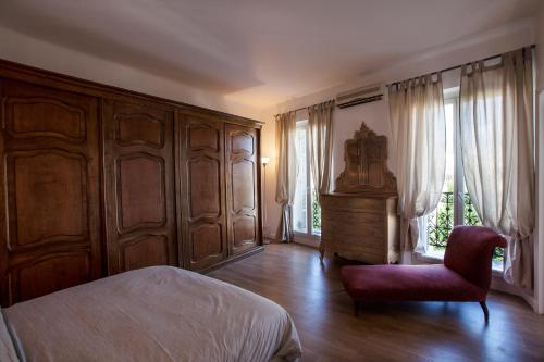 a bedroom with a bed and a chair and a window at Place au Manege in Marseille