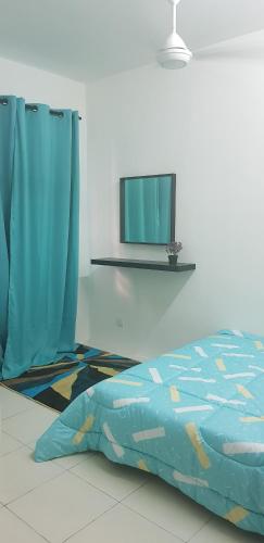 a bedroom with a bed and a tv on the wall at MY Homestay KLIA in Sepang
