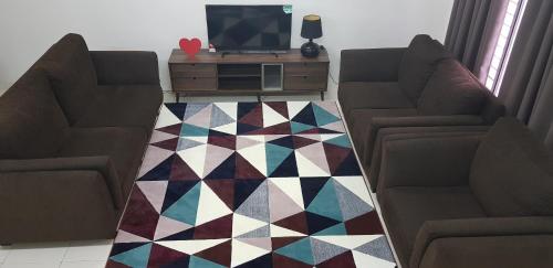 a living room with two couches and a television at MY Homestay KLIA in Sepang