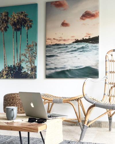a living room with a chair and a laptop on a table at Beyond Bungalows in Canggu