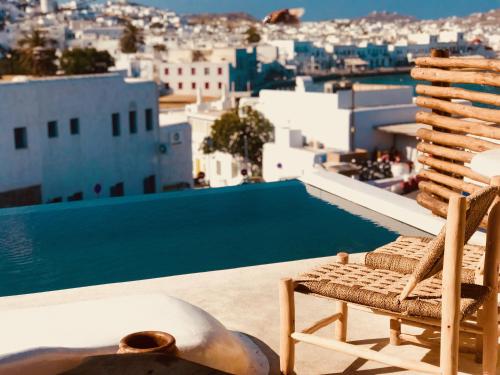 
a row of chairs sitting on top of a beach at MyCocoon Hostel in Mikonos

