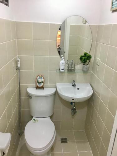 a bathroom with a toilet and a sink at Sofia's Tagaytay Getaway in Tagaytay