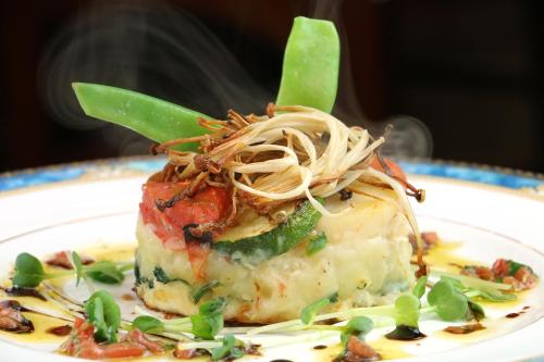 a piece of food on a plate with pasta at Petit Resort Hotel Der Barte in Zao Onsen