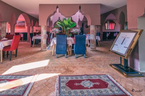 a restaurant with tables and chairs and a projection screen at Dar Ba Sidi & Spa in Chefchaouen