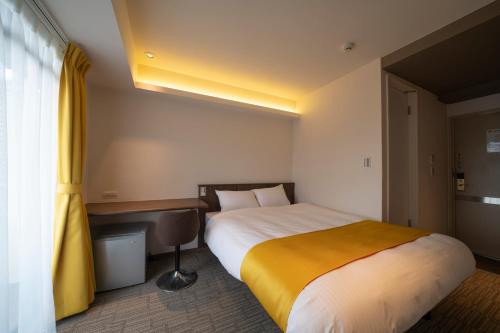 a hotel room with a bed and a desk at Terrace Kiyomizu Kyoto in Kyoto