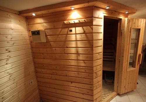 a sauna with a wooden wall at Ferienwohnung Pedall in Bischofsgrün