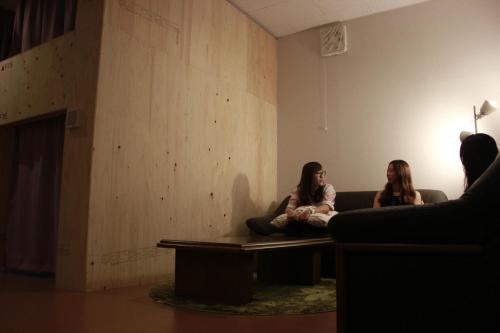 two women sitting on a couch in a room at Mezame Hostel in Nagasaki