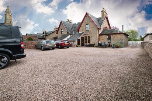 a large house with cars parked in front of it at Kylelachin in Dingwall