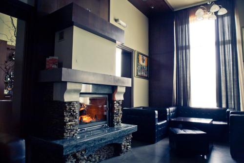 a fireplace in a living room with a fire place at Romantique Veles Hotel in Veles