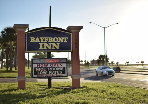 a sign for a restaurant on the side of a road at Bayfront Inn Biloxi in Biloxi