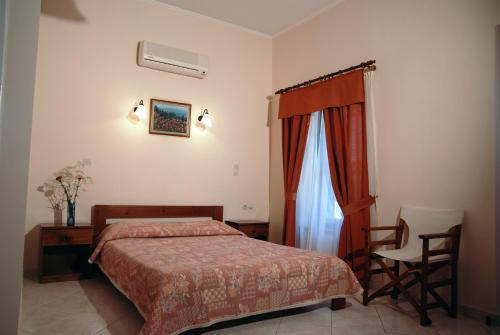 A bed or beds in a room at Krini Rooms