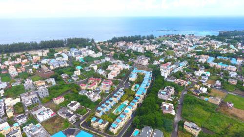 an aerial view of a city with buildings and the ocean at Grenadier A in Flic-en-Flac