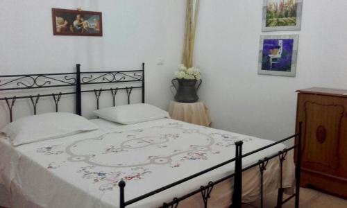 a bedroom with a bed with a black frame at Affittacamere Varone in Montaquila