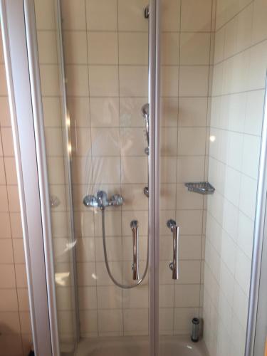 a bathroom with a shower and a tub at Appartementhaus Moser in Bad Füssing