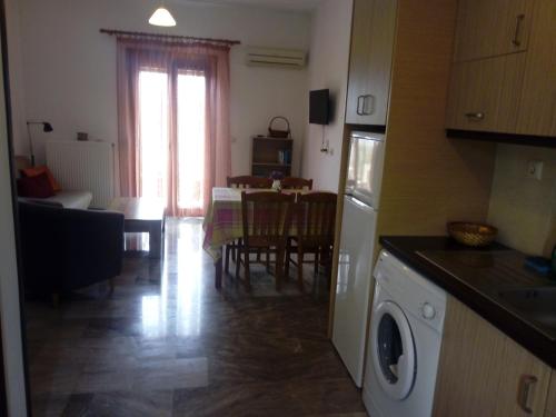 a kitchen and living room with a table and a dining room at Molivos View Studios in Mithymna