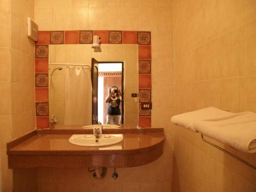 a person taking a picture of a bathroom sink at Daniela Village St.Katherine in Saint Catherine