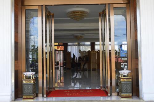 an entrance to a building with glass doors at Asia & Africa Hôtel in Antananarivo