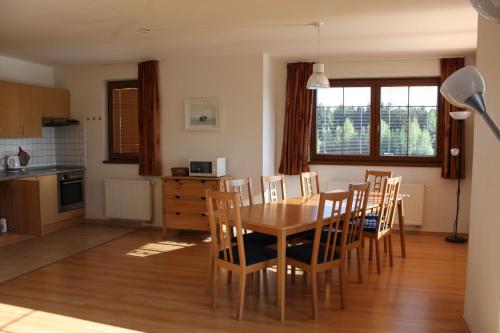 a kitchen and dining room with a table and chairs at Villa Park Lipno-Lipno-In in Lipno nad Vltavou