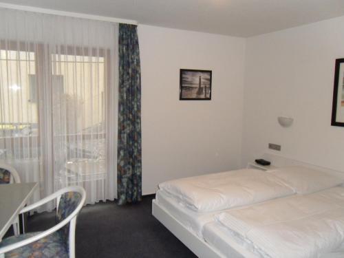 a hotel room with a bed and a window at Hotel Gasthof Traube in Kernen