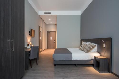 Postel nebo postele na pokoji v ubytování Hotel Bladel