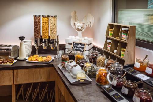 a kitchen counter with food and jars of food at AKZENT Hotel Villa Saxer in Goslar