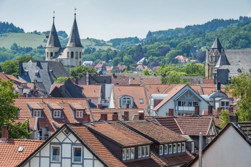 a view of a town with roofs and a church at AKZENT Hotel Villa Saxer in Goslar