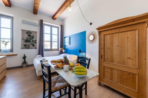 a kitchen and dining room with a table with fruit on it at JADE - LES COCONS in Marseille