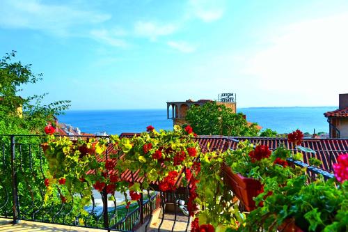 a balcony filled with lots of plants and flowers at Joro Guest House in Sveti Vlas