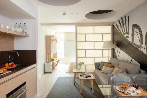 a living room with a couch and a table at Eric Vökel Boutique Apartments - Hamburg Suites in Hamburg