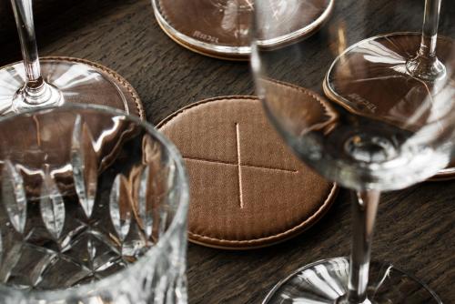 a wooden table with three wine glasses on it at At Six in Stockholm