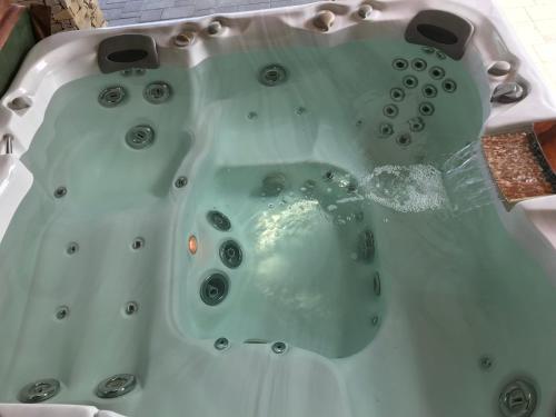 a bath tub filled with lots of water at Villa Holiday in Poroszló