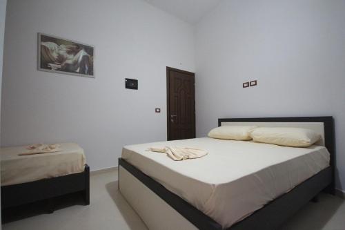 um quarto com 2 camas e toalhas em Hotel Agreno em Berat