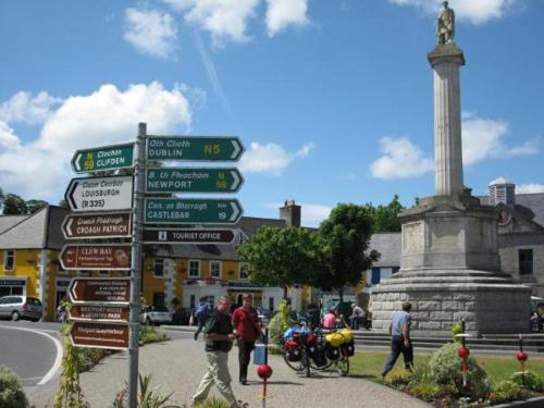 a street sign in front of a monument with street signs at Rose Alley Apartment in Westport