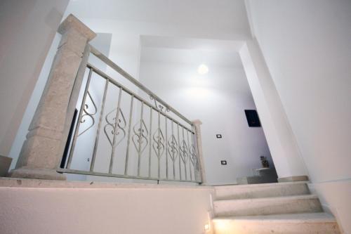 a staircase in a home with white walls and a stair case at Hotel Agreno in Berat
