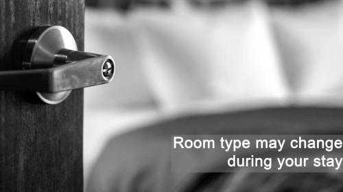 a lock on a wooden door with the words roomype may change during your step at La Piscine Art Hotel, Philian Hotels and Resorts in Skiathos Town