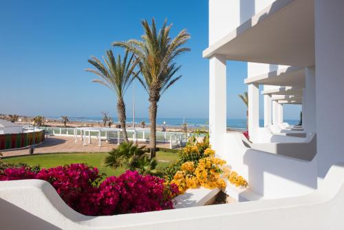 a view of the beach from the balcony of a resort at Iberostar Waves Founty Beach All Inclusive in Agadir