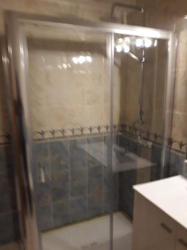 a shower with a glass door in a bathroom at Apartamento do Paim in Ponta Delgada