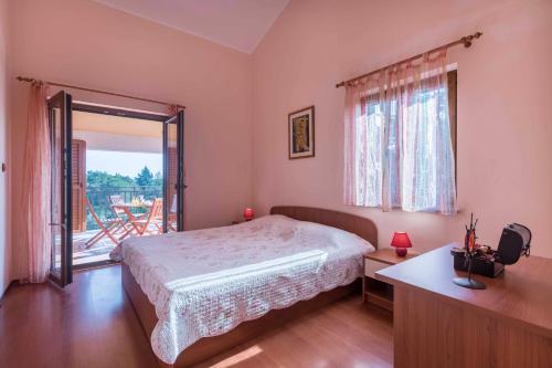 a bedroom with a bed and a large window at Apartments Villa Tre Marie in Rovinj
