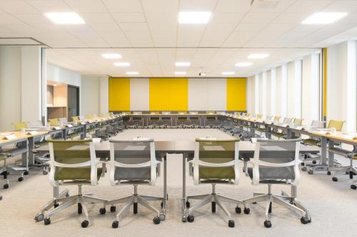 an empty conference room with a large table and chairs at Novotel Charleroi Centre in Charleroi