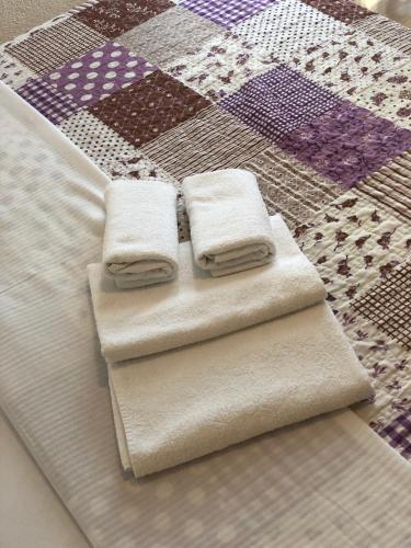 two towels are sitting on top of a quilt at Guest House Stipe in Brela