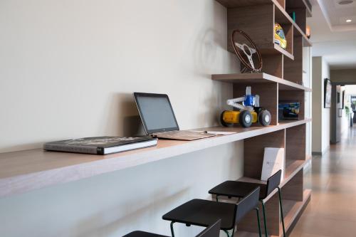 a laptop computer sitting on a counter in a room at Grand Prix Hôtel & Restaurant in Le Castellet