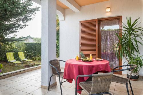 a patio with a table and chairs on a porch at Apartments Villa Tre Marie in Rovinj