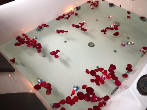 a white cake with red hearts on top of it at La Pentera in Hambegamuwa