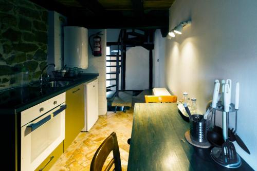 a kitchen with a wooden table in a room at Casas Canduela in Canduela