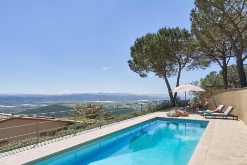 a swimming pool with a view from a house at Casa Bernardino by VacaVilla in Campiglia Marittima