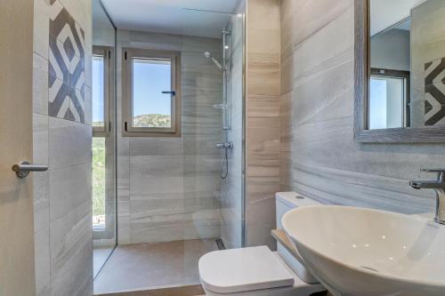 a bathroom with a sink and a toilet and a shower at Hoposa Pollentia - Adults Only in Port de Pollensa