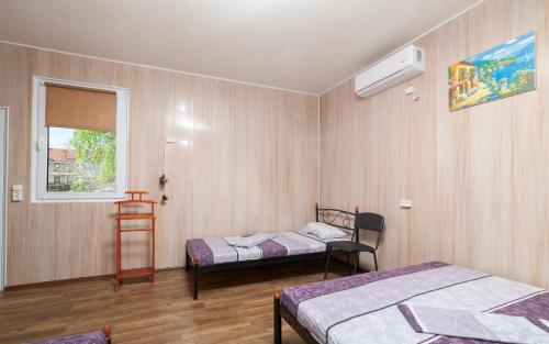 a room with two beds and a window at Мини Отель Милый in Sanzhiyka