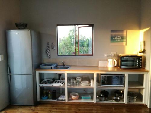a kitchen with a counter and a refrigerator at Dune View Cottage in Sodwana Bay